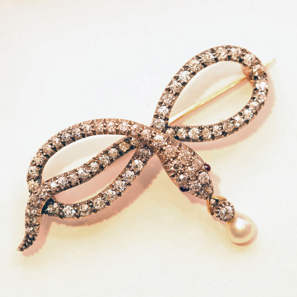 Antique Victorian snake brooch gold silver diamonds pearl garnet bow Unisex white background