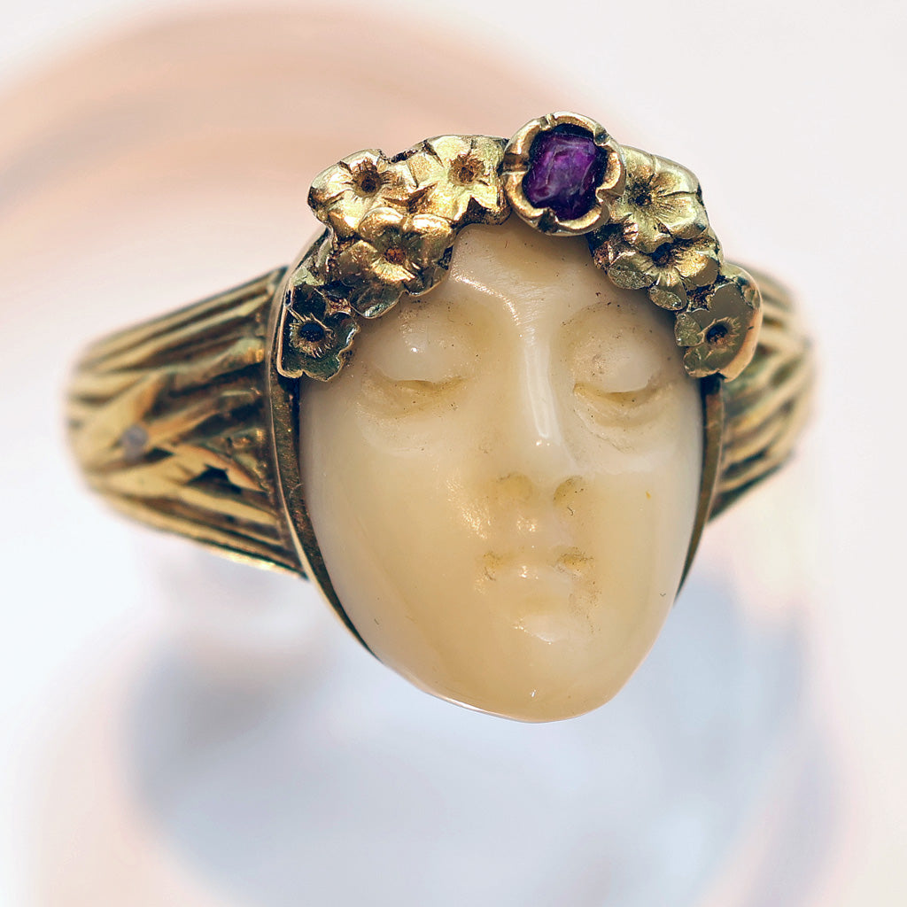 antique art nouveau ring woman gems gold white background